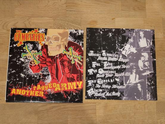 left side:
 Cover front
 Gumbabies - Another raged army 10”
  Gumbabies  band logo and a skull guy in a suite having some skelleton marionette . instead of the marionette is the title of the ep

right side: inlay with all the band members and names
