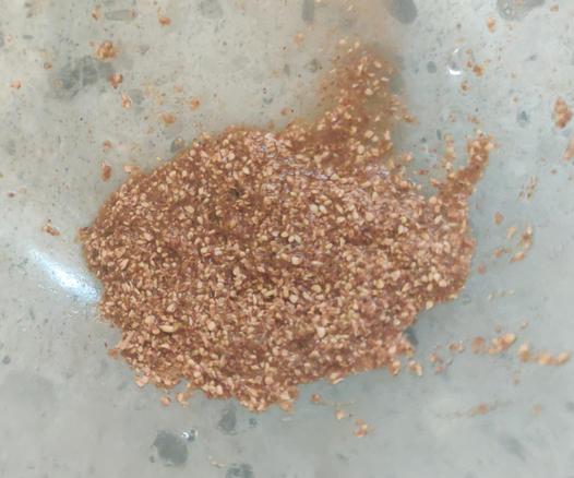 Damp seed paste. It looks brown and gritty and moist.
