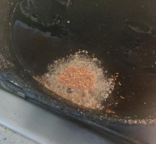 Damp seed paste in hot oil on a cast iron frypan. It's just all falling apart.