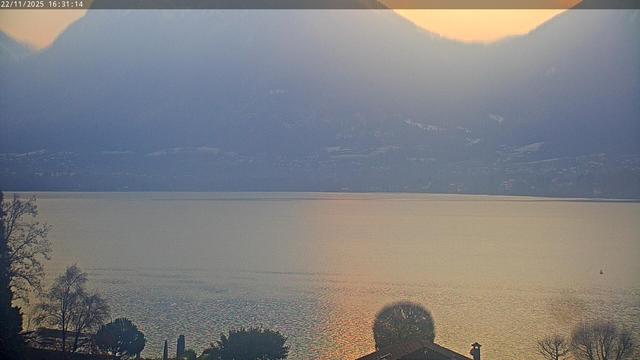 This webcam usually shows a large lake with houses on the further side away from the camera, and mountains behind it. The weather is clear. It's 23ºF/-5ºC.