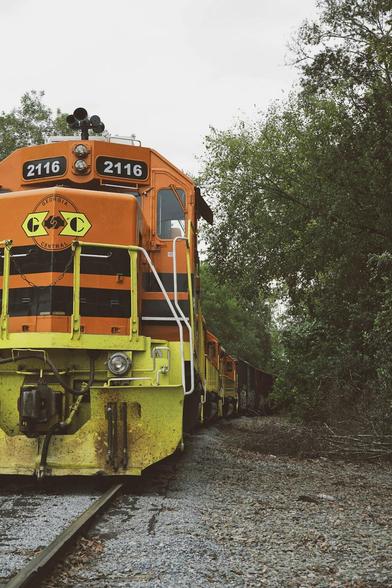 yellow and orange locomotive on rails