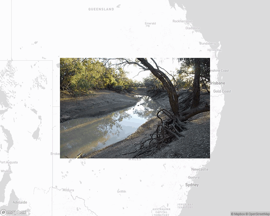 A photo of or from a national park from the linked website, overlaid on a cropped world map where it's located.