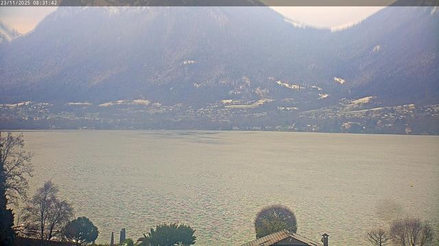 This webcam usually shows a large lake with houses on the further side away from the camera, and mountains behind it. The weather is clear. It's 27ºF/-3ºC.