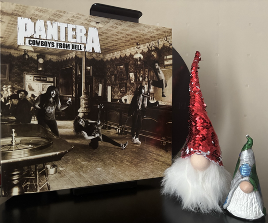 An old sepia photo of the inside of a saloon with badly superimposed black and white photos of the band members in various poses.