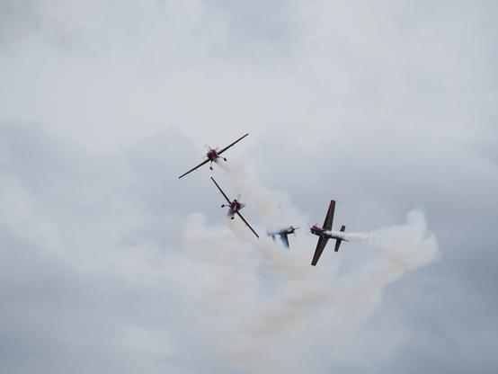 Four Royal Jordanian Falcons aircraft performing a break maneuver