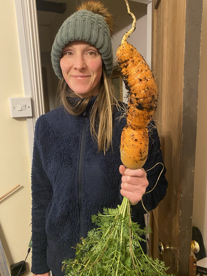 An enormous rather wonky carrot held by my wife