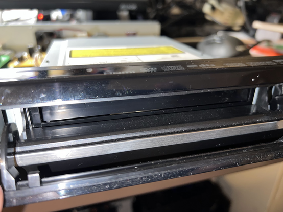 Front of the player showing a decorative flap open over an enclosed drive whose tray would push out the flap when the disc tray is opened.