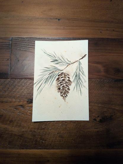 This is a watercolor painting of a branch of evergreen tree with a single pine cone hanging from it. It's painted on a 4x6 sheet of Saunders Waterford Coldpress watercolor paper. The evergreen needles are varying values of muted blue green.