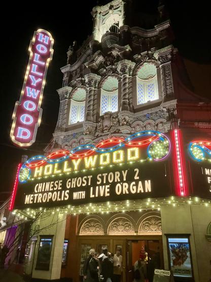 Photo shows the illuminated terra cotta facing with marquee of the historic Hollywood Theatre built in 1926 in Portland Oregon.