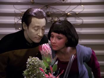 Data and his daughter Lal smelling a vase of flowers together