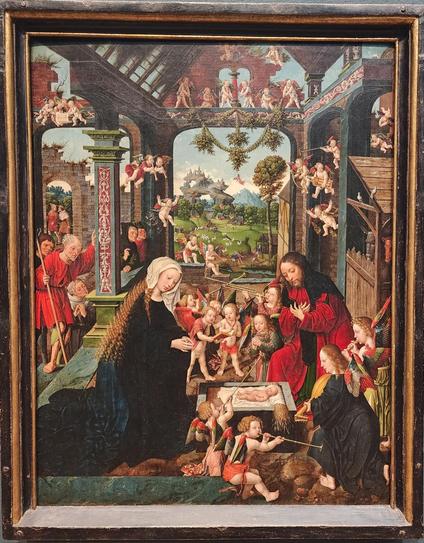 deep-perspective painting of Mary and Joseph in the stable adoring the baby Jesus in the manger, with horses and and human onlookers to the sides and background. Surrounding the holy family and scattered throughout the scene are small cherubs either naked or wearing loose red robes and playing musical instruments.