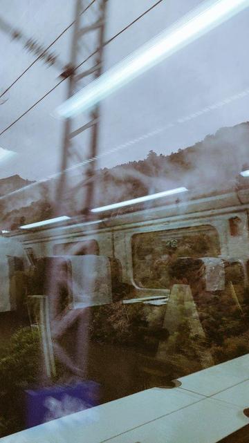 Sepia image superposing the mountains and the inside of a train wagon