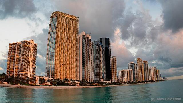 Sunny Isles Beach with a fisheye showing buildings, ocean, and sky