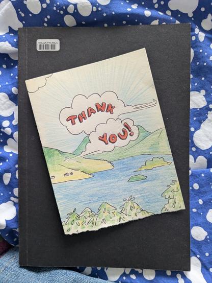 A close up of a thank you card- a hand drawn landscape and coloured with pencil crayon