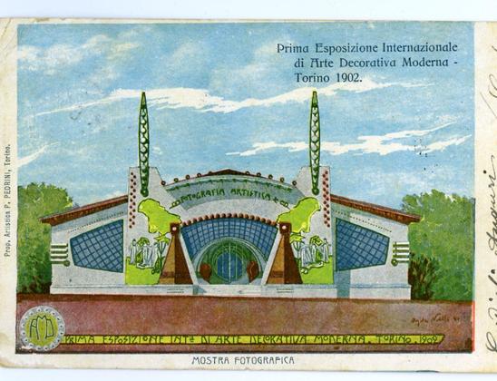 This image depicts a postcard of the "Prima Esposizione Internazionale di Arte Decorativa Moderna" held in Turin, 1902. The card shows an illustration of the main entrance or facade to this international exposition dedicated to modern decorative arts. It features prominent green and white archways with ornamental details including what appears to be classical columns at each end, a blue canopy above, and two tall, slender structures that resemble oil rigs on either side.

The background is sky-blue, adorned with faint clouds, suggesting an outdoor setting for the illustration. Atop this scene are bold inscriptions in Italian: "Prima Esposizione Internazionale di Arte Decorativa Moderna - Torino 1902" and beneath it smaller text reads "MOSTRA FOTOGRAFICA," which translates to "Photographic Exhibition." The artist's signature, P. Pedrini, is visible on the left side of the card.

The postcard appears aged with some wear at its edges, indicating that it may be an original from around this time period or a reproduction meant to mimic one. There are additional handwritten annotations in blue ink along the right edge and bottom corner which seem personal notes added later by someone else unrelated to the event's history. The card also has printed text "MOSTRA FOTOGRAFICA" at its base, indicating that it may have been distributed for a photographic exhibit related to or during this fair.

The overall impression is of an early 2 [...]