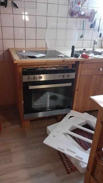 Backofen beim Einbau. Verpackungsmaterialien auf dem Boden