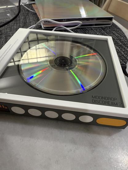 Very cute retro looking CD player. A disc spins inside