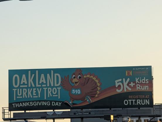 A fuller view of the Oakland Turkey Trot 5K billboard for Thanksgiving Day with would-be participants urged to register at Ott.run