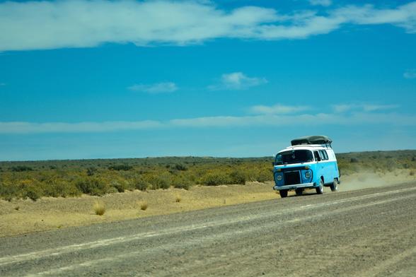 A small bus on the empty road in Patagonia