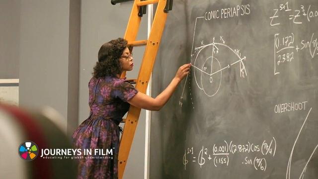 In a still photo from the film Hidden Figures, actress Taraji P. Henson as mathematician Katherine Johnson stands on a wooden ladder and writes out intricate equations on a green chalboard.

The Journeys in Film logo is in the bottom left corner.