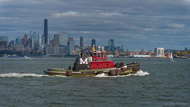 Tugboat on the Hudson river with the skyline behind
NYC