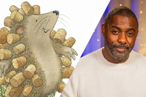 Actor Idris Elba sits beside an illustration of a smiling hedgehog character holding corks from Nick Butterworth's "The Hedgehog's Balloon"