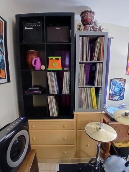 Some records, gear and toys on shelves.