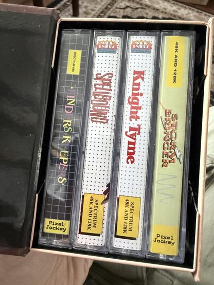 The box open showing the spines of the 4 Magic Knight games: Finders Keepers, Spellbound, Knight Tyme and Storm Bringer.