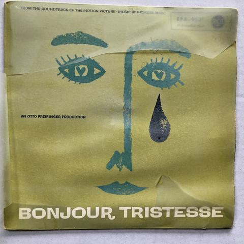 Grünes Schallplatten-Cover für den Soundtrack des Spielfilms BONJOUR TRISTESSE. Darauf mit dickem Pinselstrich zwei Augen mit Herz-Pupillen, Augenbrauen, Nase und Mund sowie eine dicke Träne.