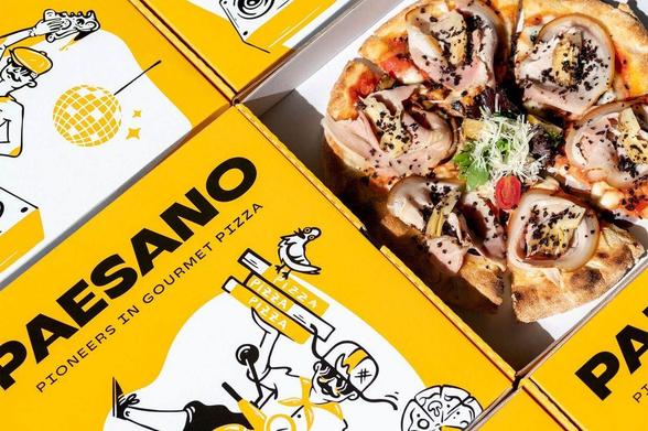 A gourmet pizza topped with meats and greens, surrounded by vibrant yellow boxes featuring playful illustrations and the "Paesano" logo.