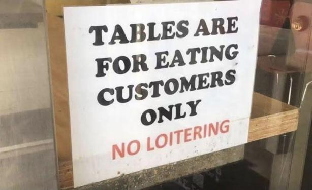 sign that says: tables are for eating customers only - no loitering