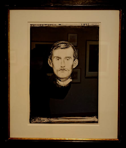 Lithografie
Der Maler schaut den Betrachter direkt an, man sieht nur sein Gesicht und einen vor ihm quer am unteren Bildrand liegenden Armknochen, der Rest des Bildes ist schwarz