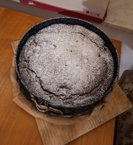 The chocolate cherry cake fresh out of the oven, coated in powdered sugar