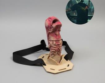The "chest burster" alien from the movie Alien, it's attached to a harness to strap around your chest so you can poke it through a hole in your shirt and pretend it's bursting out of your chest... although, the strap also makes it look like an alien-shaped strap-on dildo.