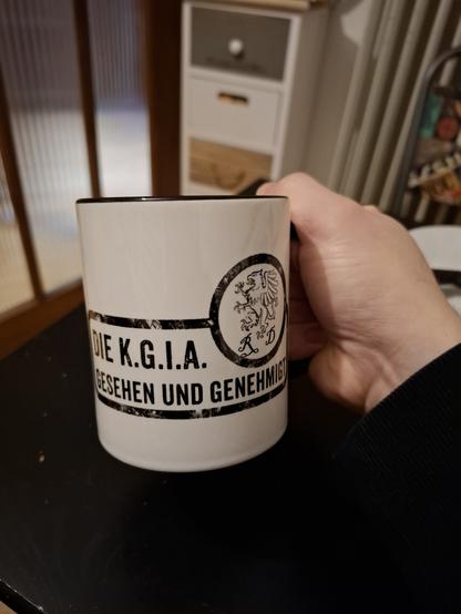 Kaffeetasse mit DSA Schriftzug "Die KGIA gesehen und genehmigt"