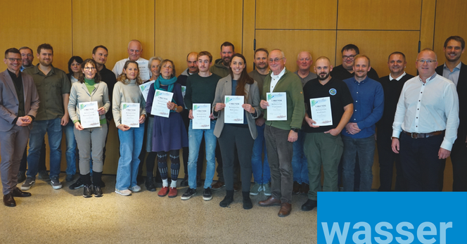 Gruppenbild von den neuen Bachpaten aus dem Landkreis Donau-Ries mit ihren Urkunden sowie Bürgermeistern und Vertretern der Fachbehörden.