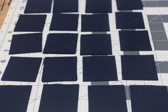 Small black fabric squares arranged not very tidily on a cutting mat.
I need to cut over 300 of these squares. I will split the task over tonight and tomorrow evening.
