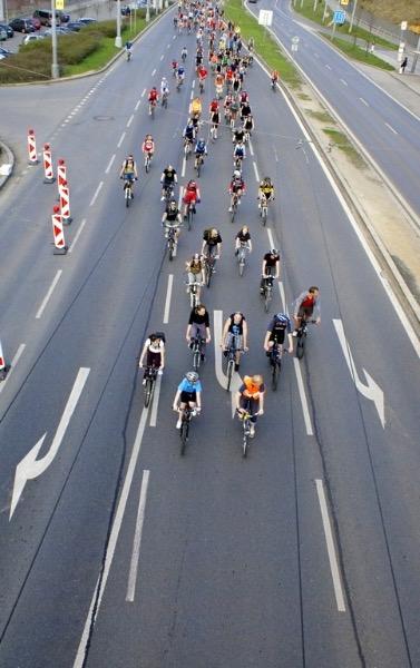 Cyclists panning multiple lanes on a street.