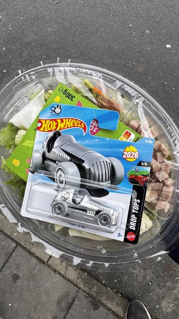 Fischersalat im transparenten Behälter mit Hot Wheels Spielzeugauto und Gutscheinen.