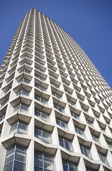 A colour photograph looking up at Centre Point, a concrete office block converted into apartments