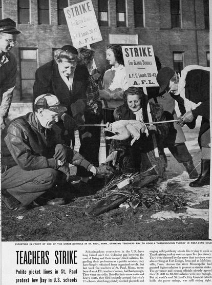 Newspaper headline of the St Paul teachers strike. Image shows men and women crouched in front of a street fire, where they are roasting a chicken. They are wearing heavy coats, scarves, gloves. Some are carrying picket signs.