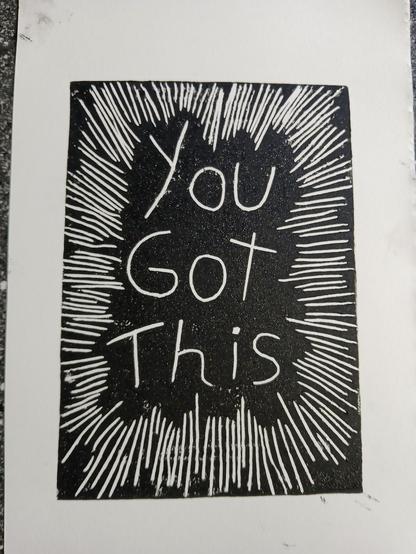 Black-and-white lino print with the words “You Got This” in the centre, surrounded by hand-carved radiating lines like bright rays.