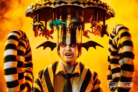 Beetlejuice wears a carousel on his on his head with his arms rolled up ready to cause come chaos.