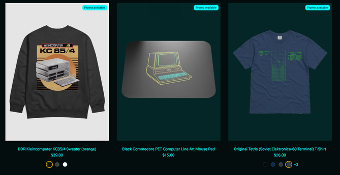 Screenshot of the store showing three articles:
A gray sweatshirt with an orange design of the KC 85/4 computer; A Mouse mat with line art of the Commodore PET computer
A blue T-shirt with the original TETRIS ASCII screen as it appeared on the Elektronica-60's terminal