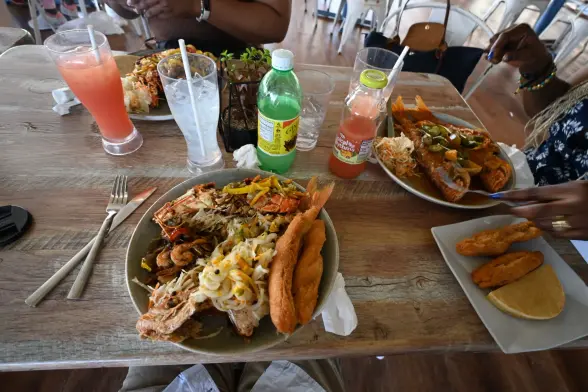 My food on a plate in front of me, the Pirate’s Catch, which is half a lobster, shrimps, fish, with lots of season and with two festivals on top. My wife to the right had the two big fish and her daughter in front of me had lobsters which was three half-lobsters. The others with us had a variety of other items including another Pirate’s Catch, two children’s food, and fish soups etc. Lots of good food.