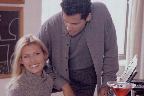 1998 A Moment in a Creative Studio

In this image, we see two individuals engaged in what appears to be an artistic collaboration within a cozy and creative space. The person on the left is wearing a gray sweater with subtle speckles, suggesting a casual yet stylish attire fitting for a relaxed studio environment.

The individual on the right is dressed in a layered ensemble of a brown buttoned shirt under a dark blazer paired with striped trousers, exuding an air of professionalism and readiness. His posture indicates attentiveness as he leans slightly forward over what seems to be a piece of artwork or sketches placed on an easel beside him.

The studio background features various artistic elements such as a framed drawing that resembles abstract art on the wall behind them and scattered papers with inkblots, hinting at a brainstorming session in progress. A partially visible red drink adds a splash of color to the scene, possibly symbolizing creativity or celebration within their work environment.

Overall, this image captures an intimate snapshot into the lives of two artists immersed in their creative process, surrounded by tools and inspiration characteristic of a productive studio setting.

Artistic Collaboration