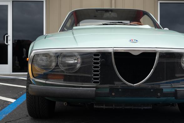 Front grille detail. The car has a clear plastic shield over its headlights, with vertical capsule-shaped holes.