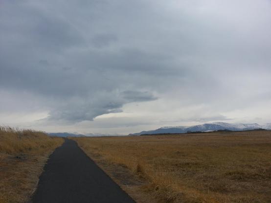 walking path through grass land outside Reykjavík Iceland on a cloudy day