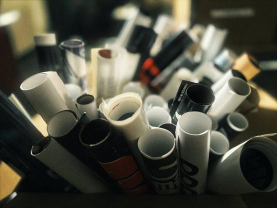 Multiple photos of the Hollywood Theatre archive display movie posters, film reels, a splicing table, and a giant sign that reads, "BEN HUR."