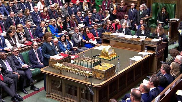 Rachel Reeves speaking at the despatch box in the House of Commons during the Autumn Budget 2025, with MPs seated on green benches.